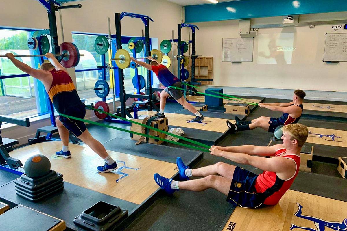 Student athletes undergoing strength and resistance in the gym